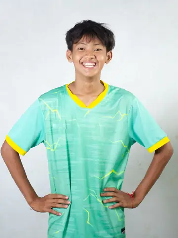 A young footballer in a teal kit